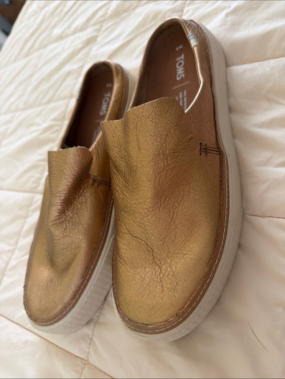 Toms women’s Slip-On Loafers in Metallic Gold